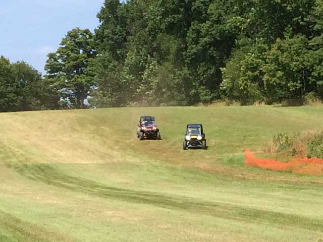 side by side ATVs in field